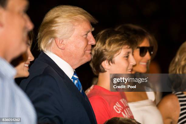 President Donald Trump , with First Lady Melania Trump and their son Barron , walks to the White House from Marine One on the South Lawn of the White...