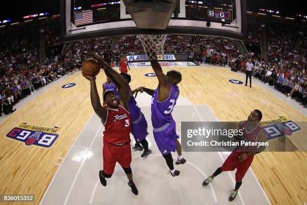 Al Harrington of the Trilogy drives to the basket against Ricky Davis of the Ghost Ballers in week nine of the BIG3 three-on-three basketball league...