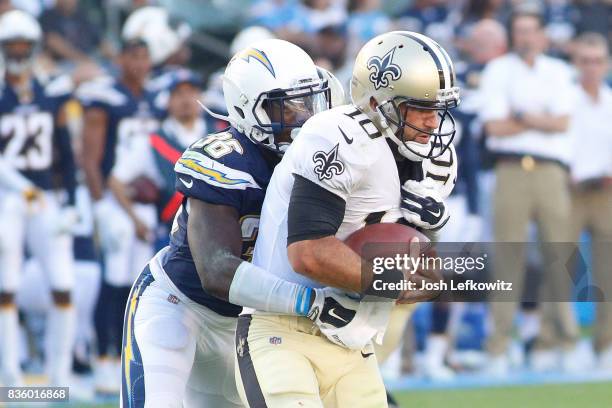 Desmond King of the Los Angeles Chargers tackles quarterback Chase Daniels of the New Orleans Saints during the game between the Los Angeles Chargers...