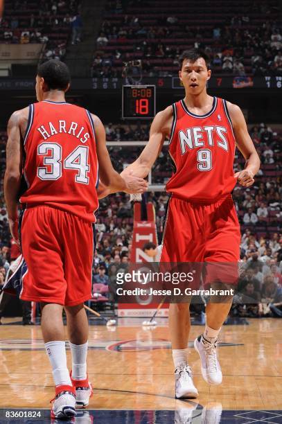Yi Jianlian of the New Jersey Nets celebrates a play with teammate Devin Harris during the game against the Golden State Warriors on November 1, 2008...