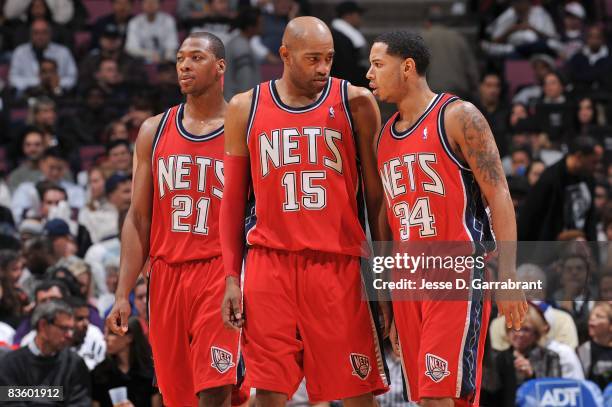 Bobby Simmons, Vince Carter and Devin Harris of the New Jersey Nets walk on the court during the game against the Golden State Warriors on November...