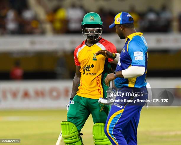 In this handout image provided by CPL T20, Chadwick Walton of Guyana Amazon Warriors congratulated by Dwayne Smith of Barbados Tridents during Match...