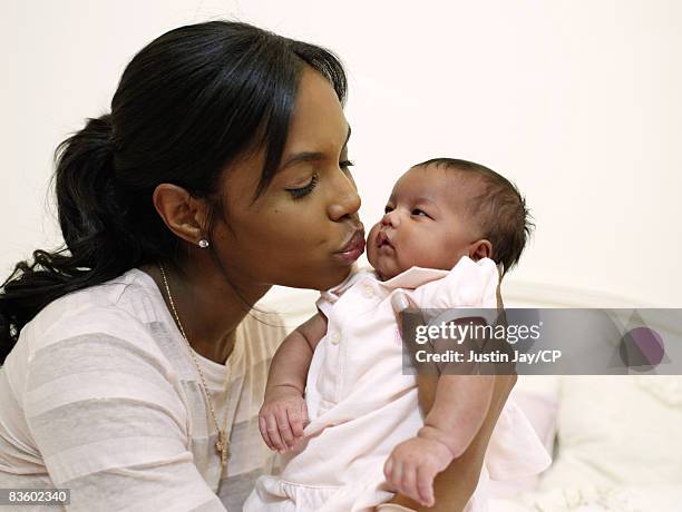 Kim Porter at home in New Jersey with baby daughter D'Lila Star on January 24, 2007. Credits: Make up: Merrell Hollis/Ken Barboza Assoc.; Sean Comb's...