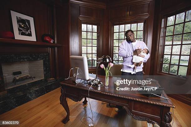 Sean Combs holds baby daughter D'Lila Star at home in New Jersey on January 24, 2007.Credits: Make up: Merrell Hollis/Ken Barboza Assoc. Sean Comb's...