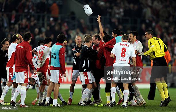 Assistant coach Roland Koch of Koeln celebrates with the players after winning the Bundesliga match between 1. FC Koeln and Hannover 96 at the...