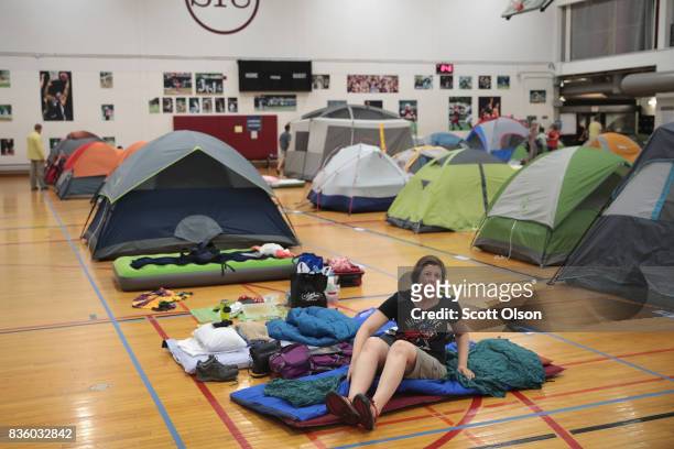 Campers, in town to view the solar eclipse, relax at their indoor campsites on the campus of Southern Illinois University the evening before Monday's...
