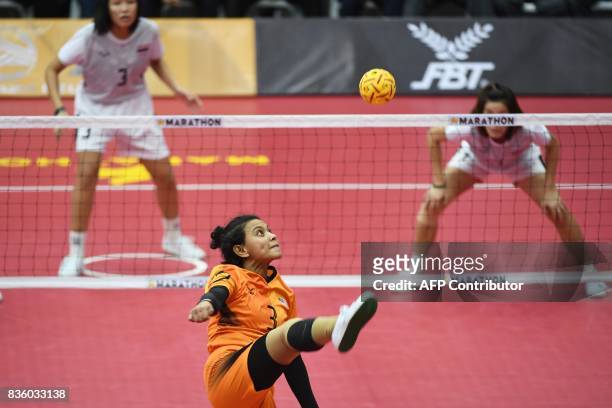 Siti Norzubaidah binti Cheab Wahab of Malaysia kicks a ball against Thailand during their women's group preliminary round robin sepak takraw match of...