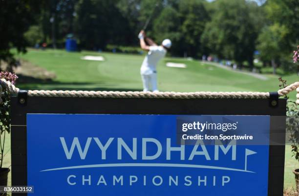 Chez Reavie tees off on the 2nd hole in front of the Wyndham Championship sign during the final round of the Wyndham Championship on August 20, 2017...