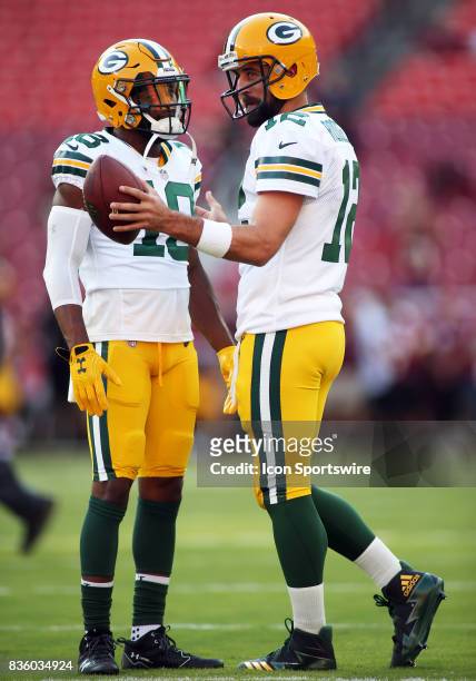 Green Bay Packers quarterback Aaron Rodgers in action with Green Bay Packers wide receiver Randall Cobb before a match between the Washington...