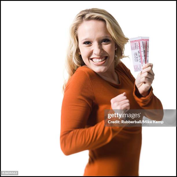 woman holding concert tickets - concert ticket stock pictures, royalty-free photos & images