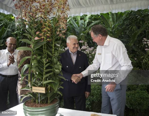 Turkish Prime Minister Binali Yildirim shakes hands with Director of National Orchid Garden Dr. Nigel Taylor at Singapore Botanic Gardens in...