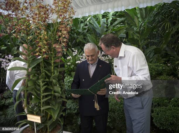 Turkish Prime Minister Binali Yildirim speaks with Director of National Orchid Garden Dr. Nigel Taylor at Singapore Botanic Gardens in Singapore on...