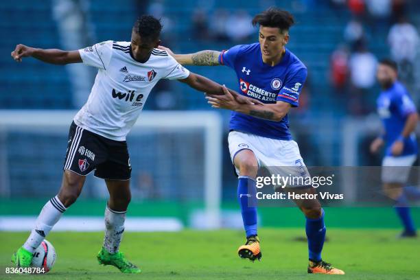 Fidel Martinez of Atlas struggles for the ball with Enzo Roco of Cruz Azul during the fifth round match between Cruz Azul and Atlas as part of the...