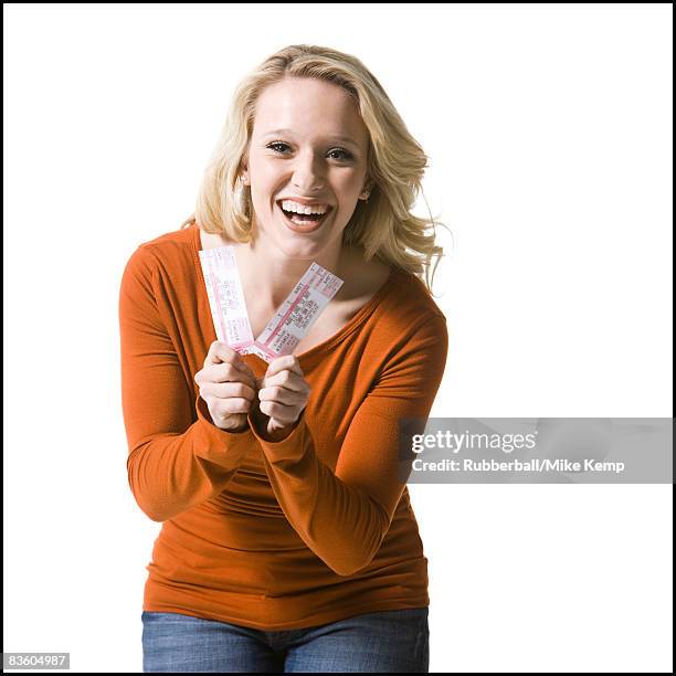 woman holding concert tickets - concert ticket stock pictures, royalty-free photos & images