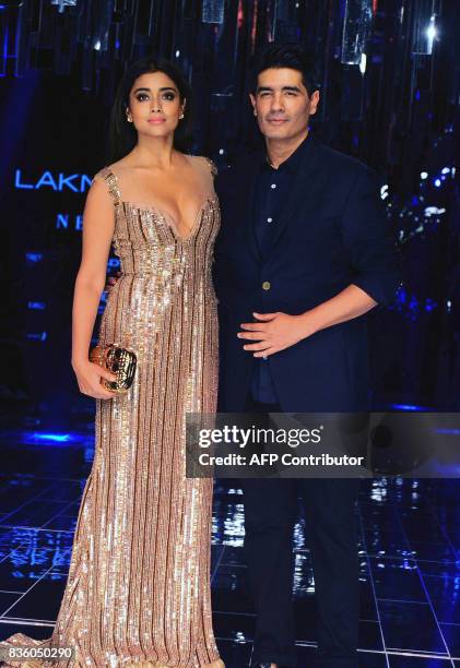 Indian Bollywood actress Shriya Saran and designer Manish Malhotra pose for a photograph during the grand finale of Lakme Fashion Week Winter/Festive...