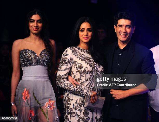 Indian Bollywood actress Sridevi Kapoor with daughter Jhanvi and designer Manish Malhotra pose for a photograph during the grand finale of Lakme...