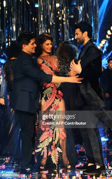 Indian Bollywood actors Jacqueline Fernandez and Aditya Roy Kapur showcase a creation by designer Manish Malhotra during the grand finale of Lakme...