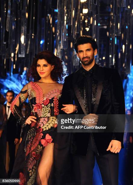 Indian Bollywood actors Jacqueline Fernandez and Aditya Roy Kapur showcase a creation by designer Manish Malhotra during the grand finale of Lakme...