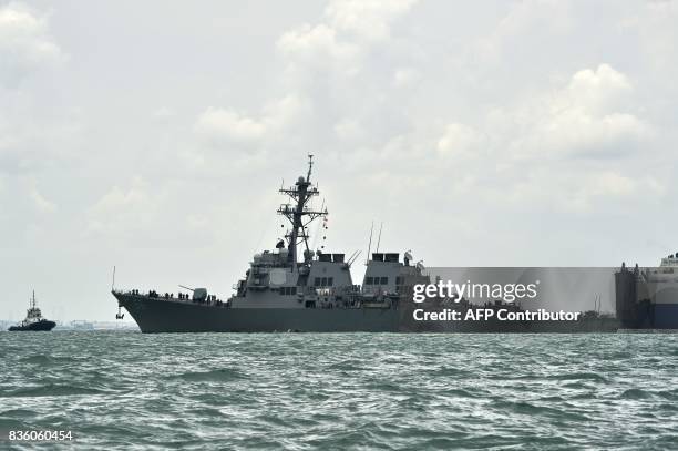 General view shows the guided-missile destroyer USS John S. McCain with a hole on its left portside after a collision with oil tanker, outside Changi...