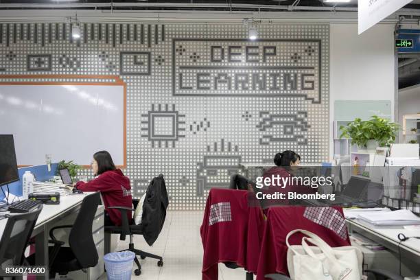 Employees work in front of computers at the Sinovation Ventures headquarters in Beijing, China, on Tuesday, Aug. 15, 2017. Sinovation Ventures'...