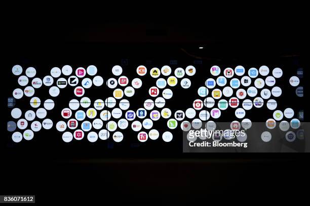 The logos of various startup companies in which Sinovation Ventures have invested are illuminated on a display panel at the venture's headquarters in...