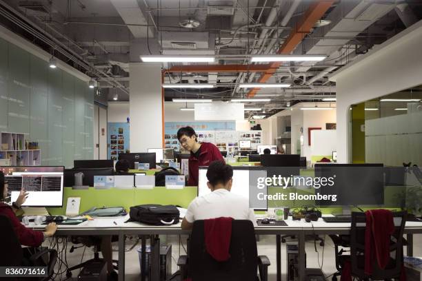 Employees work in front of computers at the Sinovation Ventures headquarters in Beijing, China, on Tuesday, Aug. 15, 2017. Sinovation Ventures'...