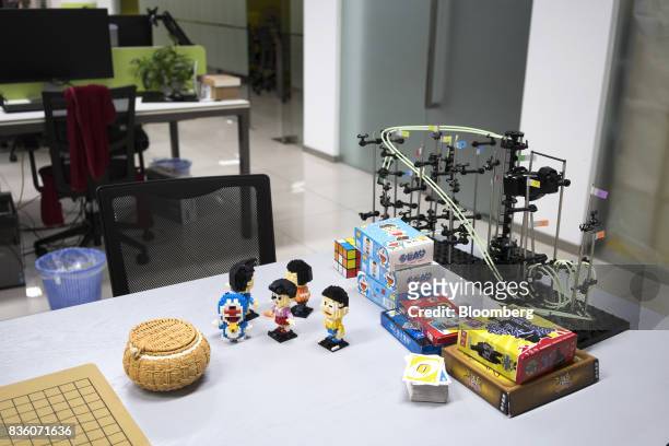 Various toys and card games sit on a table at the Sinovation Ventures headquarters in Beijing, China, on Tuesday, Aug. 15, 2017. Sinovation Ventures'...