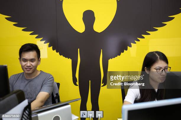 Employees work in front of computers at the Sinovation Ventures headquarters in Beijing, China, on Tuesday, Aug. 15, 2017. Sinovation Ventures'...