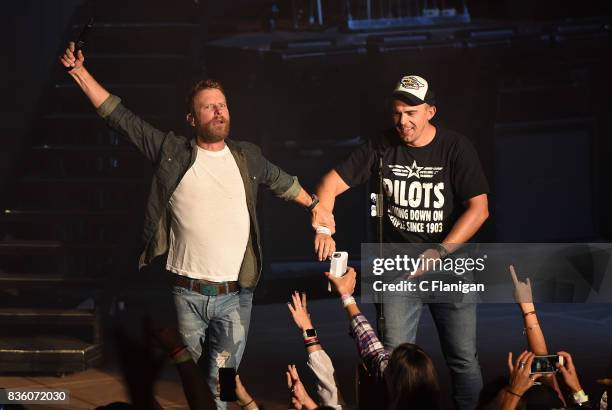 Dierks Bentley brings a fan onstage to 'shotgun' a beer during his 'What The Hell' world tour at Shoreline Amphitheatre on August 20, 2017 in...