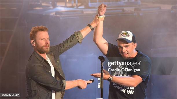 Dierks Bentley brings a fan onstage to 'shotgun' a beer during his 'What The Hell' world tour at Shoreline Amphitheatre on August 20, 2017 in...