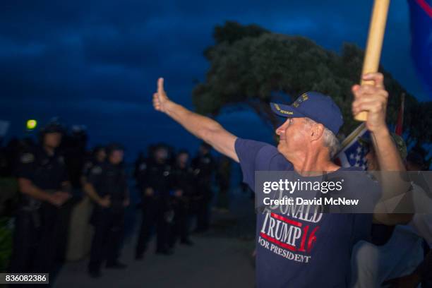 Demonstrators yell at counter demonstrators beyond a police line separating the two during an 'America First' demonstration on August 20, 2017 in...