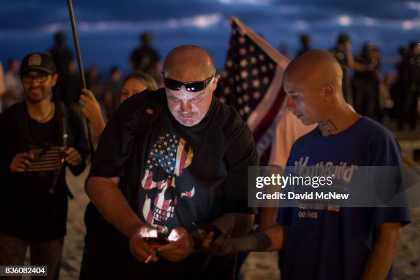 Conservative demonstrators rally at an 'America First' demonstration on August 20, 2017 in Laguna Beach, California. Organizers of the rally describe...