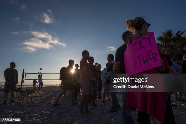 People play beach volleyball near counter demonstrators during an 'America First' demonstration on August 20, 2017 in Laguna Beach, California....