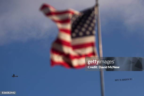 An airplane tows a counter protest message above an 'America First' demonstration on August 20, 2017 in Laguna Beach, California. Organizers of the...