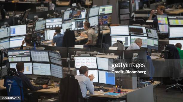 Traders monitor data on banks of desktop computer monitors on the RWE AG energy trading floor in Essen, Germany, on Wednesday, Aug. 16, 2017. RWE...