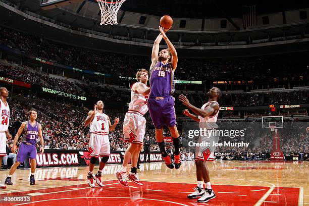 Robin Lopez of the Phoenix Suns goes for a dunk past Aaron Gray and Ben Gordon of the Chicago Bulls during the NBA game on November 7, 2008 at the...