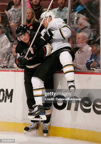 Stephane Robidas of the Dallas Stars is checked into the boards by Chris Kunitz of the Anaheim Ducks during the game on November 7, 2008 at Honda...