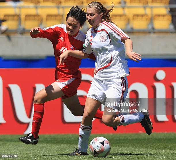 Line Ostergaard of Denmark gets tackled by Jon Myong Hwa of Korea during the FIFA U-17 Women`s World Cup Quarter final match between Denmark and...