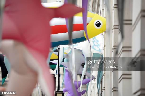 Greenpeace protestors hold the inflatable sea creatures up to the windows of the BP headquarters after delivering petitions during a protest parade...