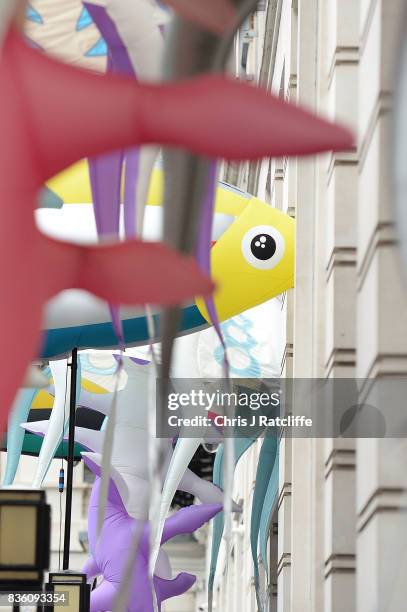 Greenpeace protestors hold the inflatable sea creatures up to the windows of the BP headquarters after delivering petitions during a protest parade...