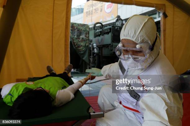 Emergency services personnel wearing protective clothing participate in an anti-terror and anti-chemical terror exercise as part of the 2017 Ulchi...