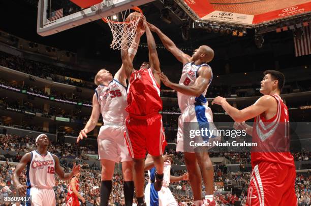 Carl Landry of the Houston Rockets attempts a dunk against Chris Kaman and Brian Skinner of the Los Angeles Clippers at Staples Center on November 7,...