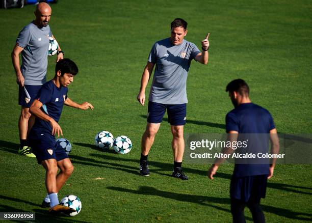 Head Coach of Sevilla FC Eduardo Berizzo gives instructions to Borja Lasso of Sevilla FC during the training session prior to their UEFA Champions...