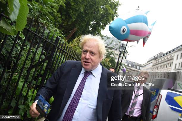 Boris Johnson, Secretary of State for Foreign and Commonwealth Affairs receives a leaflet from Greenpeace protestors near the BP headquarters during...