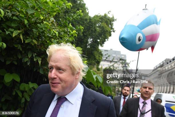 Boris Johnson, Secretary of State for Foreign and Commonwealth Affairs passes Greenpeace protestors near the BP headquarters during a protest in St....
