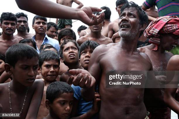 Villagers come to collect water refining tablets from the volunteers in Islampur, Jamalpur, Bangladesh, on 19 August 2017.