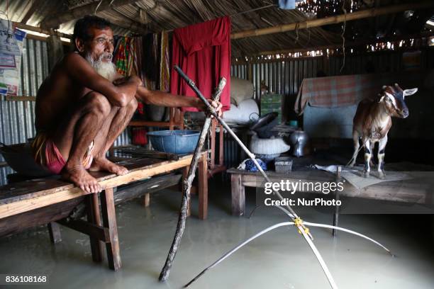 Man sets fishing trap inside his house in Islampur, Jamalpur, Bangladesh, on 19 August 2017.