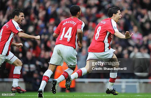 Samir Nasri of Arsenal celebrates with Theo Walcott and Francesc Fabregas as he scores their second goal during the Barclays Premier League match...