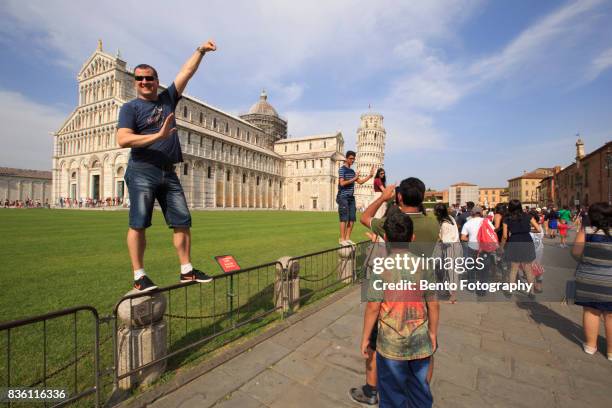 tourists take pictures of the leaning tower on july 20, 2017 in pisa, italy. - travel20 stock pictures, royalty-free photos & images