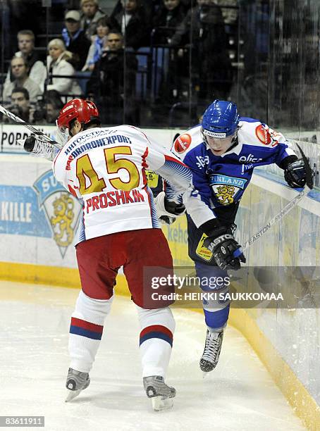 Russia's Vitaly Proshkin fights for the puck with Finland's Lennart Petrell during their Euro Hockey Tour Karjala Cup match in Helsinki, Finland, on...